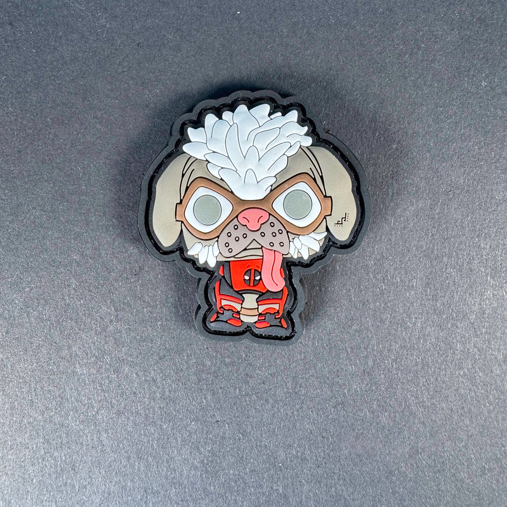 PVC patch of a cartoon-style dog wearing a Deadpool-inspired costume with its tongue out.