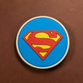 Round Superman PVC patch with red and yellow emblem on a blue background