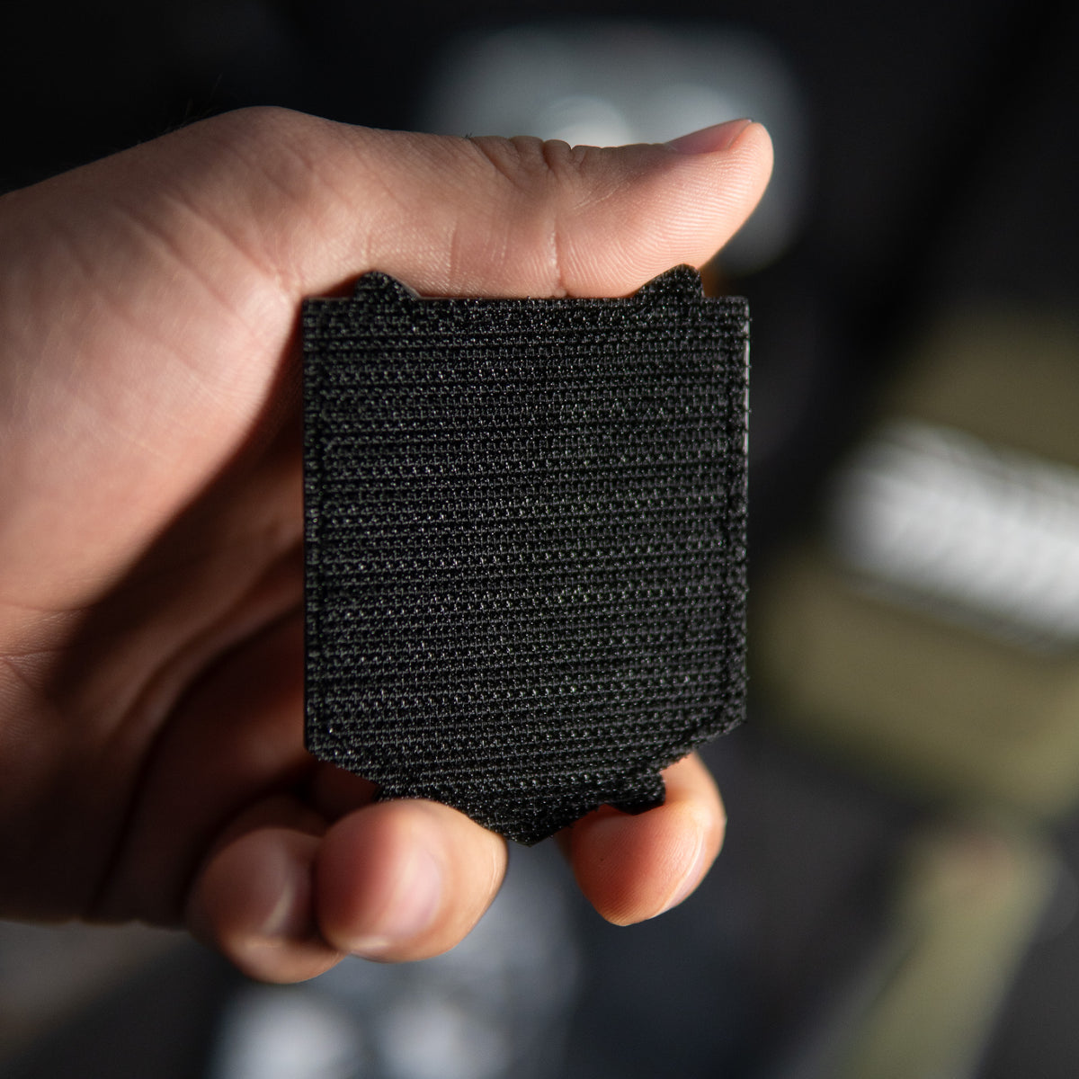 Back of Attack on Titan PVC morale patch showing the black hook backing