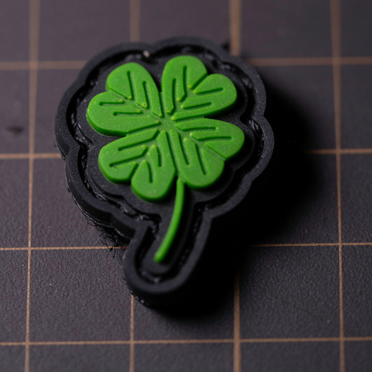 Close-up of Clover PVC morale patch with green four-leaf clover design