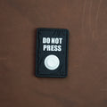 Black Do Not Press PVC morale patch with white 3D button detail