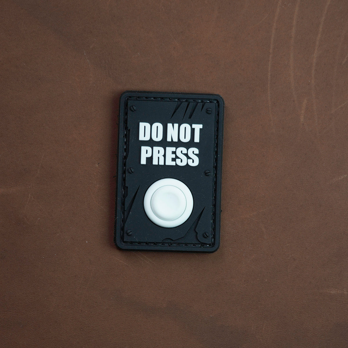 Black Do Not Press PVC morale patch with white 3D button detail