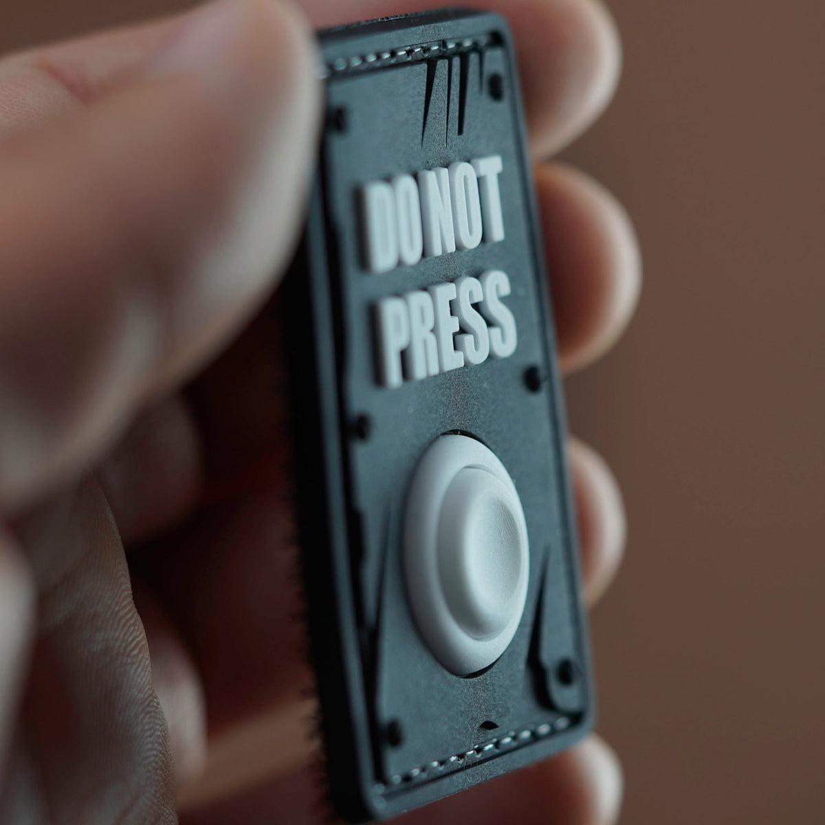 Black Do Not Press PVC morale patch with raised white button
