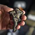 Droppin Bombs Pin-Up Girl PVC morale patch held in a hand