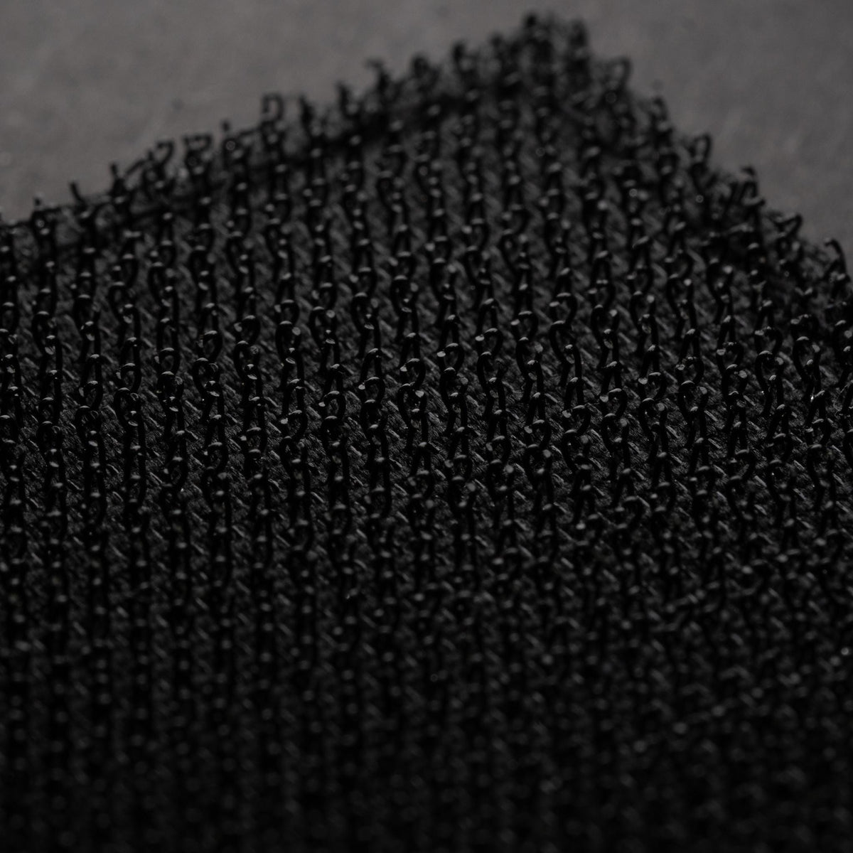 Back of Left Unsupervised PVC morale patch showing black hook backing
