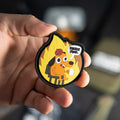 This Is Fine PVC morale patch held in a hand