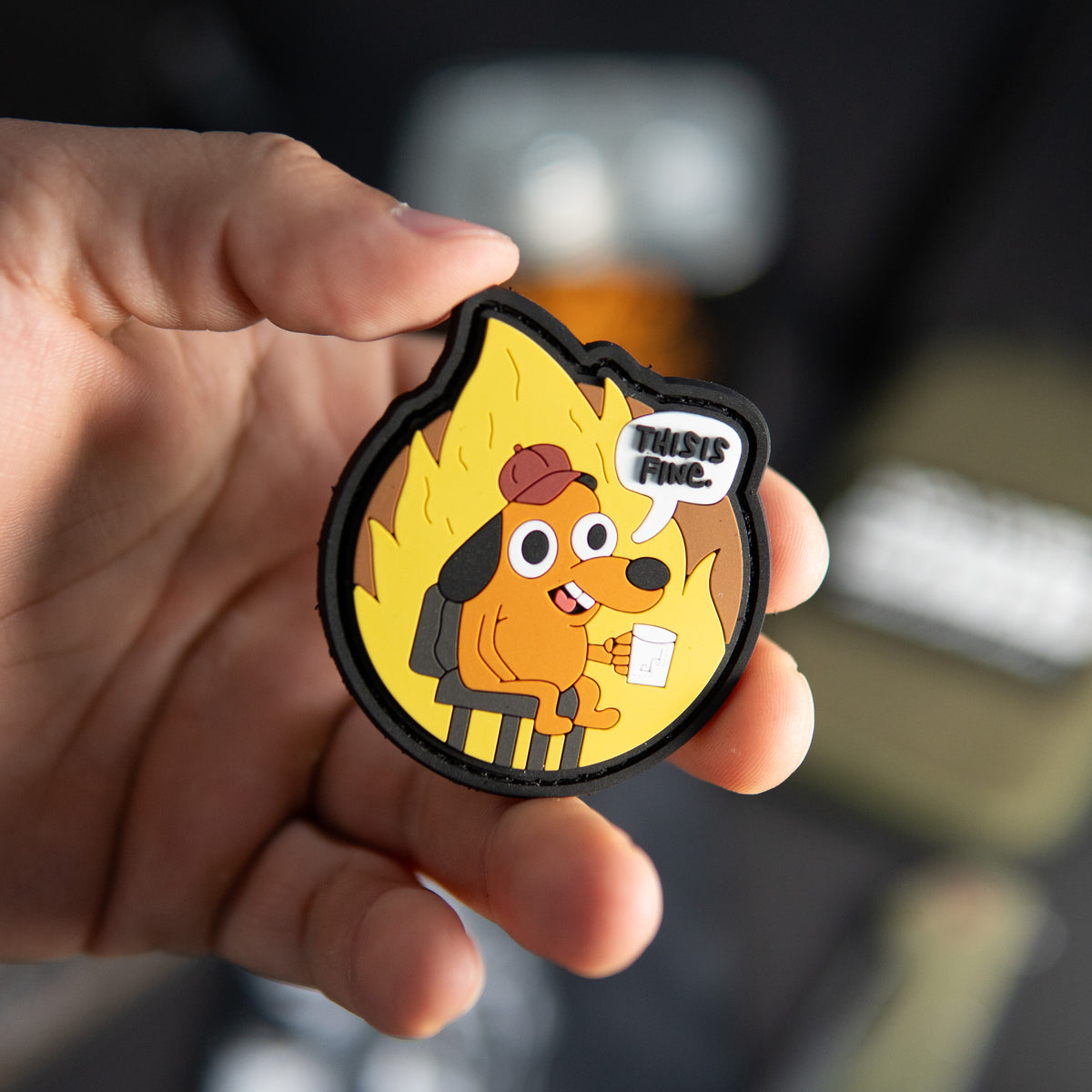 This Is Fine PVC morale patch held in a hand