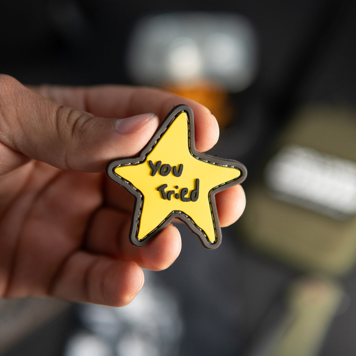 You Tried PVC morale patch with yellow star design held in a hand